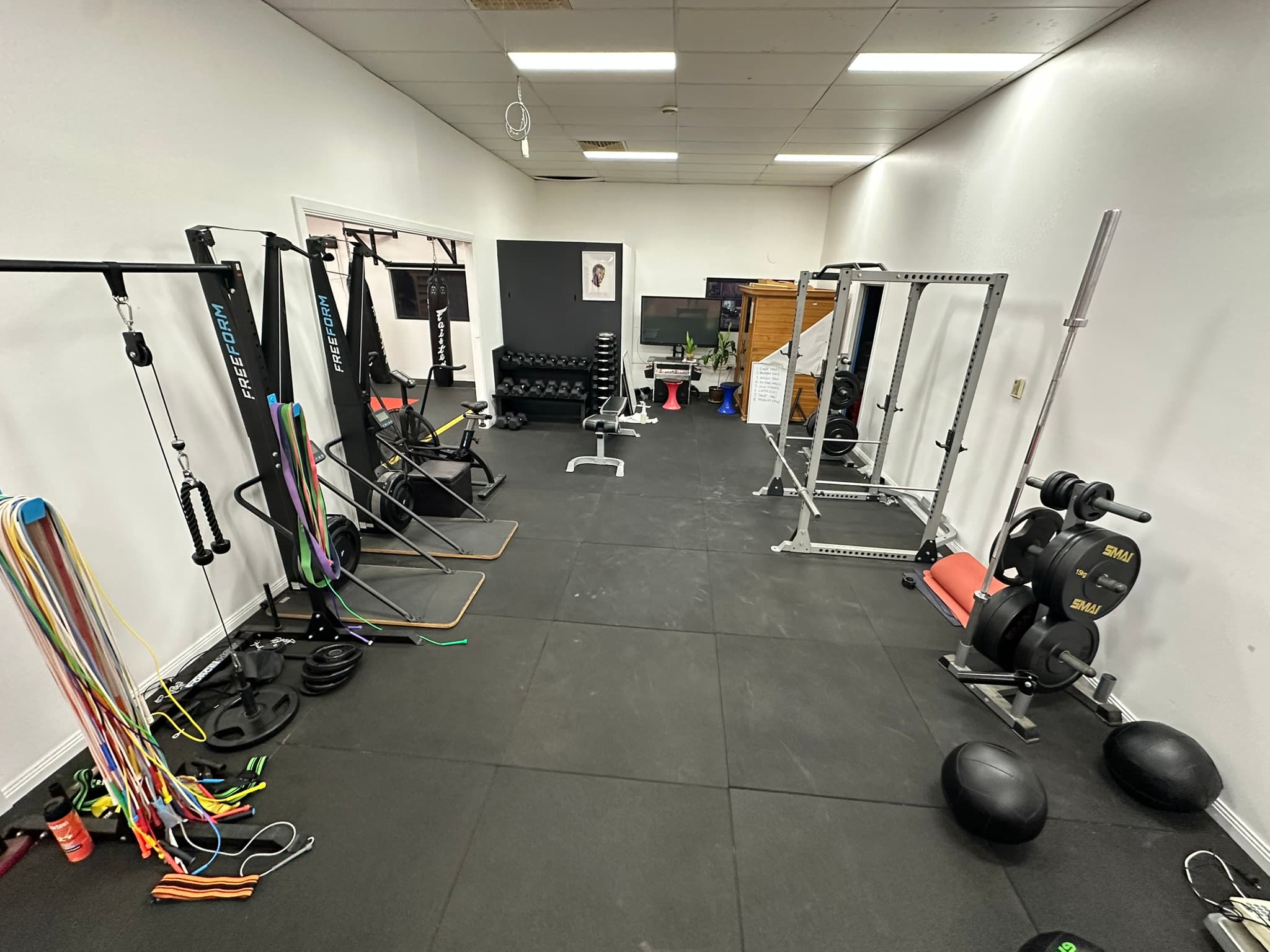 The strength and conditioning room — racks, cables, and free weights