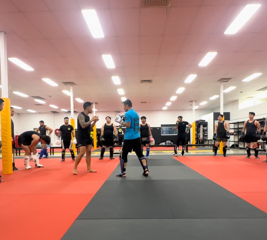 Two students standing opposite in kickboxing stance